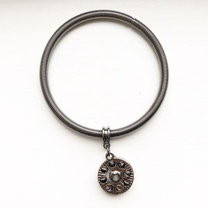Metallic gray metal coil & wheel pendant bracelet